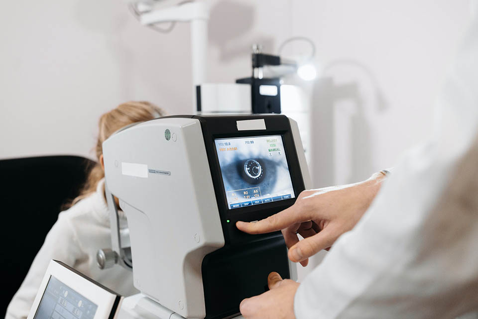 Image of optometrist executing eye exam