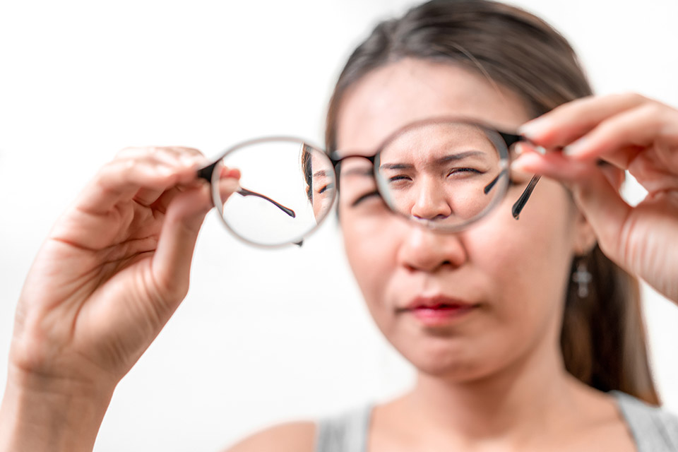 Asian woman holding glasses on white background, Selective focus